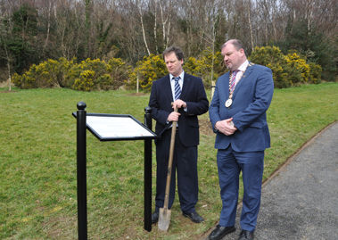 Fergal Doherty, Area Engineer with Cllr Ciarán Brogan, Cathaoirleach reading the plaque to mark the planting of seven trees for the seven signatories to commemorate the 1916 Rising.
