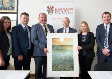 Dr. Peter FitzGerald being presented with a special gift of a painting of the Dorlin Beach, Loughris Point by Fionntan Gogarty, from Cllr. Ciaran Brogan, Cathaoirleach of Donegal County Council.  Also in the photo Cllr. Marie Therese Gallagher, Seamus Neely, Nuailin FitzGerald and Dr. Ciaran Richardson.
