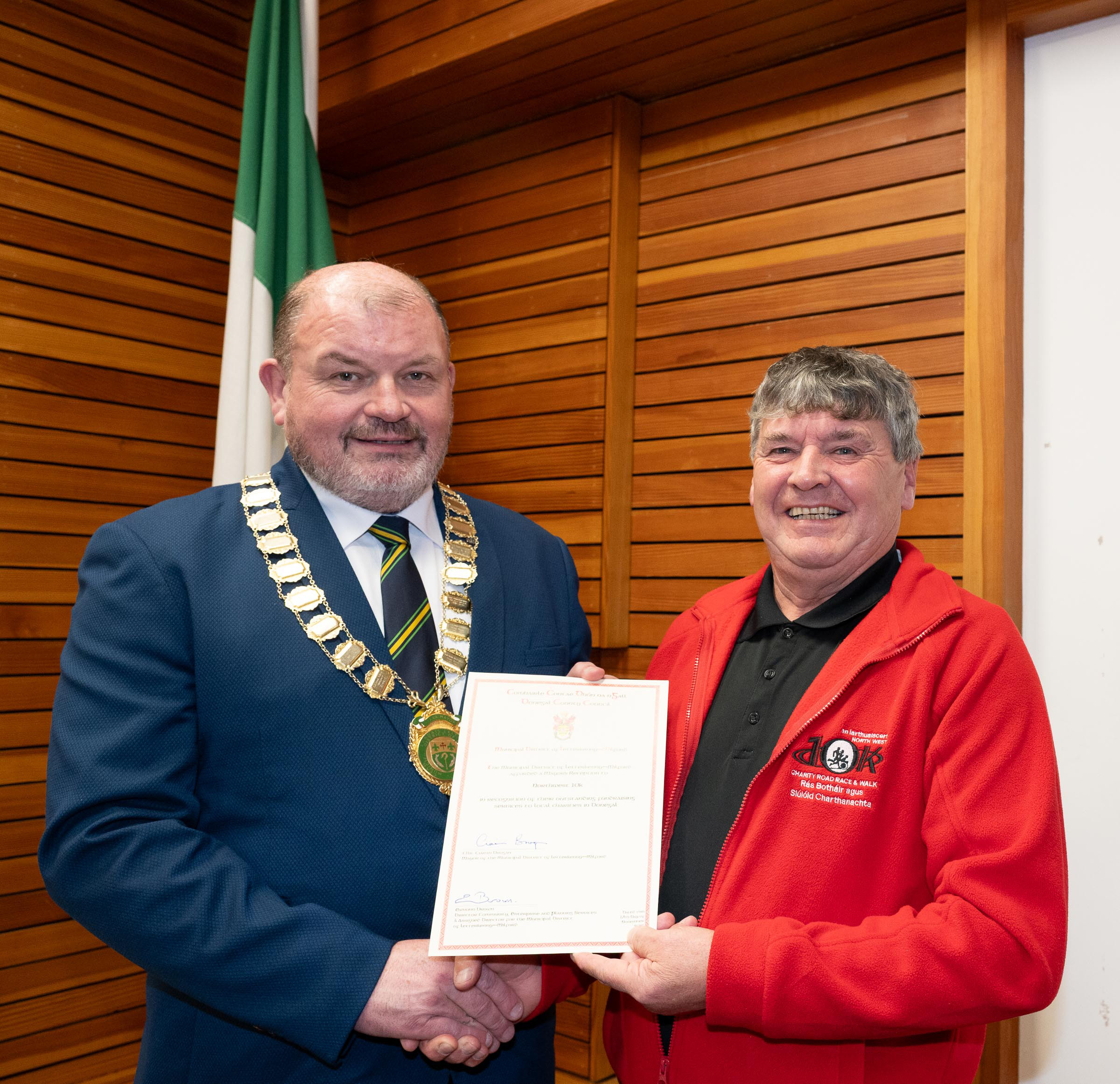 Cllr Ciaran Brogan, Mayor of Letterkenny and Milford Municipal District presenting the scroll to Neil Martin, Chairperson of the North West 10K at the Letterkenny & Milford Municipal District Mayor's reception for the North West 10k. Photo Clive Wasson