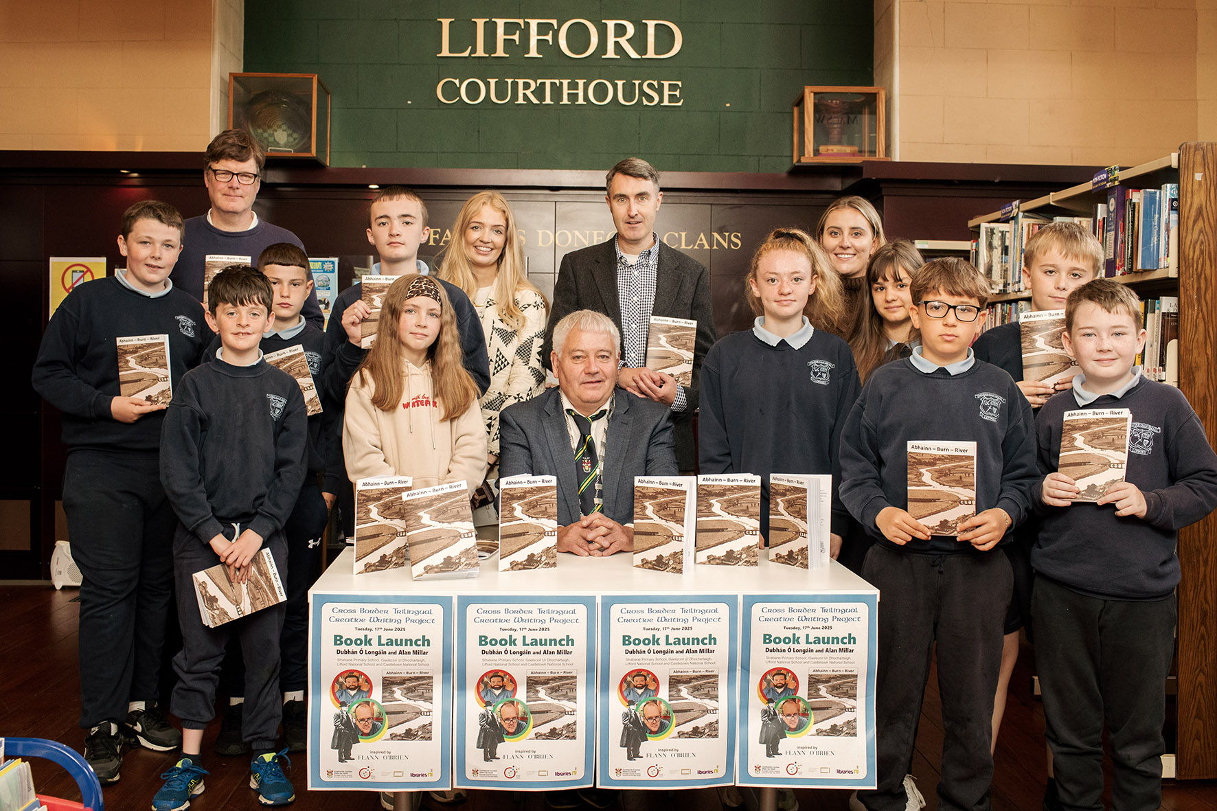 Cathaoirleach of Lifford-Stranorlar MD Councillor Martin Harley pictured with students and teachers from Lifford National School and staff from Donegal County Library Service at the launch of the book Abhainn Burn River in Lifford Library.
